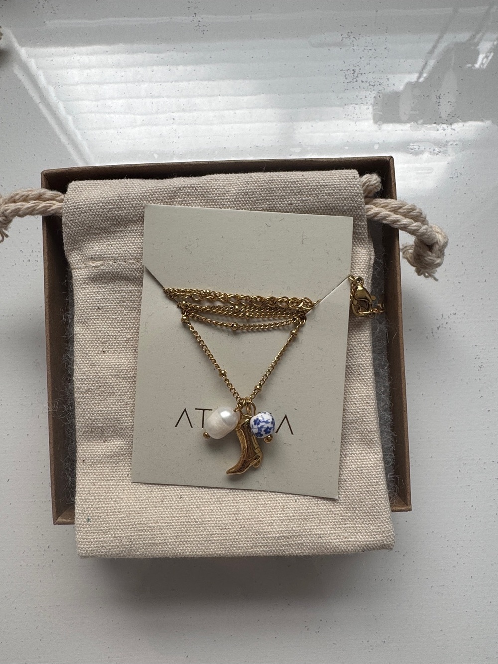 Gold Layered Necklace with Cowgirl Boot, Pearl and Blue-White Ceramic Charm